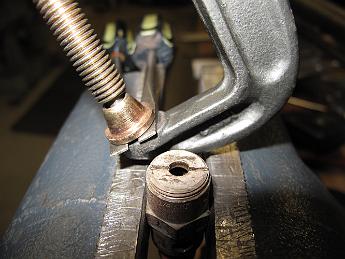  A poor man's spanner wrench -- two screwdrivers held with a c-clamp.  Hey, it did the job.